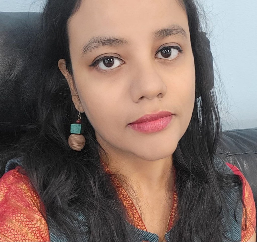 Woman with black hair and red dress posing for picture