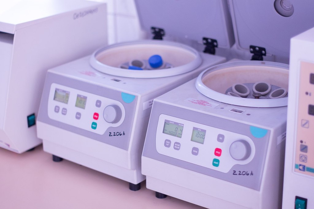 Two centrifuges on desk